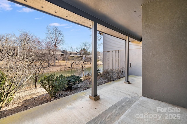 view of patio with a water view