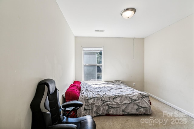 bedroom with carpet floors, baseboards, and visible vents