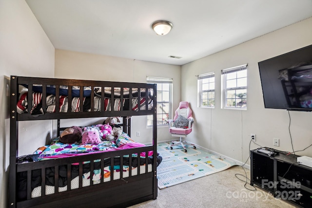 bedroom with baseboards, visible vents, and carpet flooring