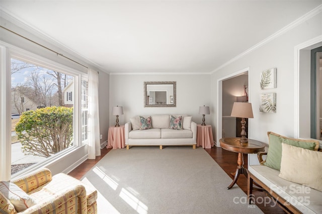 living area with ornamental molding and wood finished floors