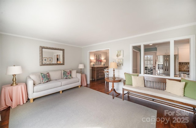 living area with crown molding and wood finished floors