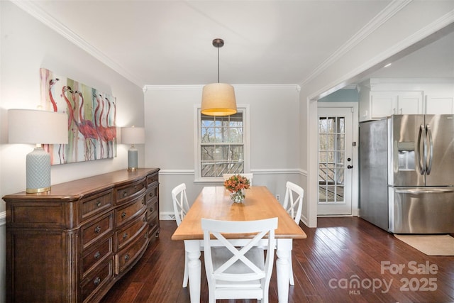 dining space with dark wood-style floors and ornamental molding