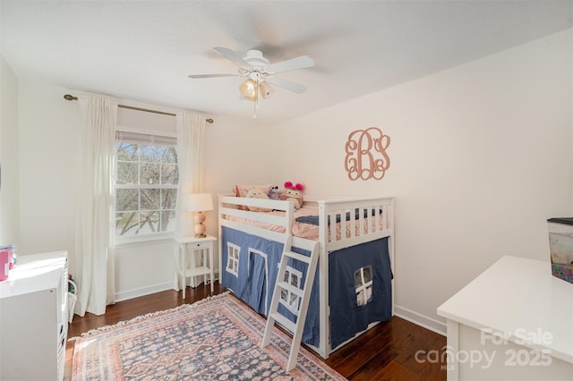 bedroom with ceiling fan, wood finished floors, and baseboards