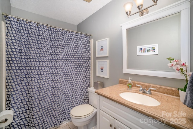 full bath featuring a textured ceiling, toilet, and vanity