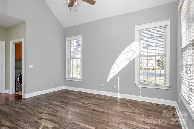 spare room with washer / dryer, baseboards, a ceiling fan, and wood finished floors