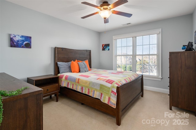 bedroom featuring light carpet, visible vents, ceiling fan, and baseboards