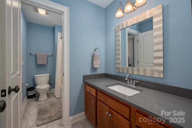 bathroom featuring tile patterned floors, baseboards, toilet, and vanity