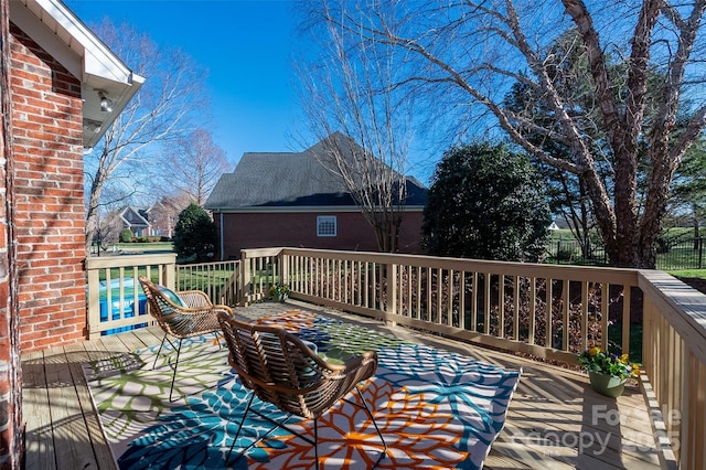 wooden terrace featuring fence