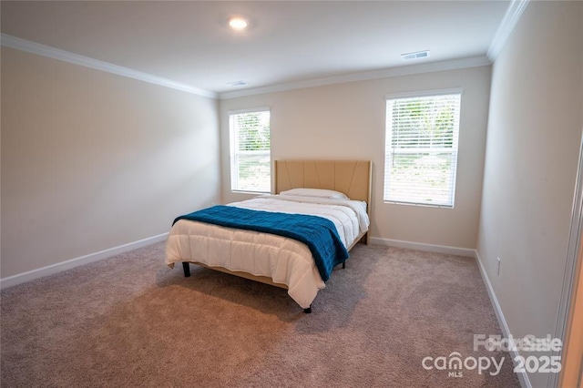 bedroom with baseboards, carpet, and crown molding