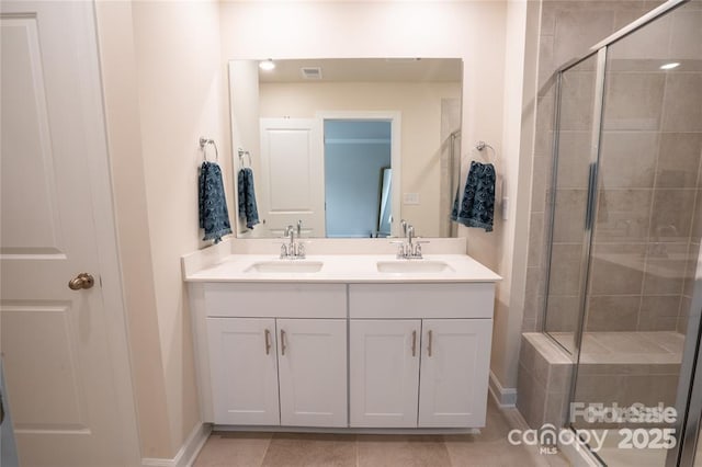 full bathroom featuring double vanity, a sink, and a shower stall