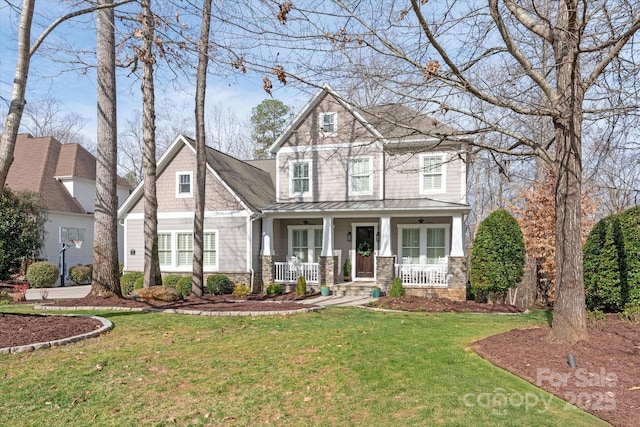 craftsman house featuring a porch, a front yard, a standing seam roof, ceiling fan, and metal roof