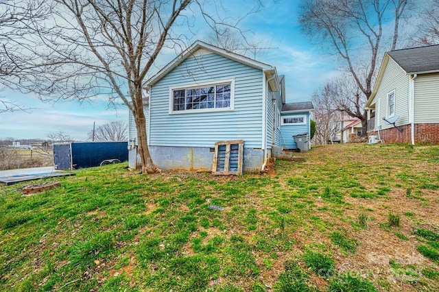 back of property featuring a lawn