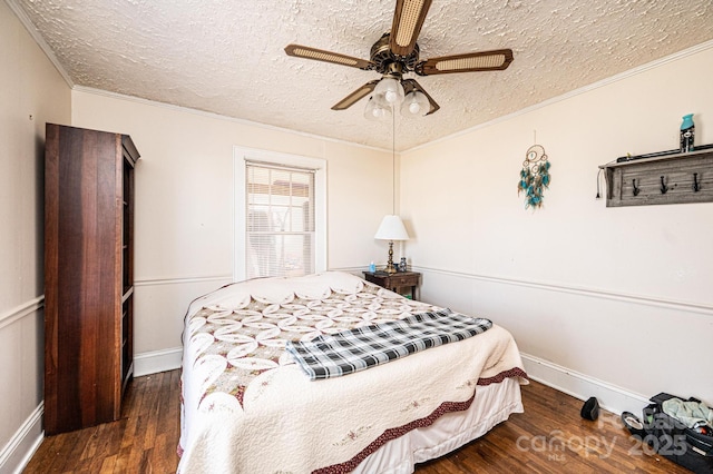 bedroom featuring a textured ceiling, ornamental molding, and wood finished floors