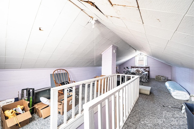 additional living space featuring carpet flooring and vaulted ceiling