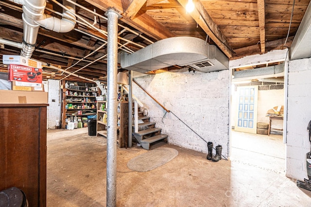 unfinished basement with stairway and visible vents