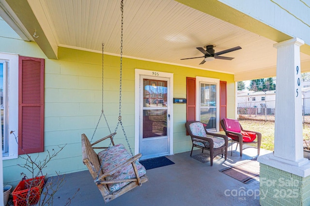 property entrance with a porch and a ceiling fan