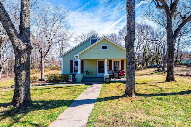 bungalow-style home with a porch and a front lawn