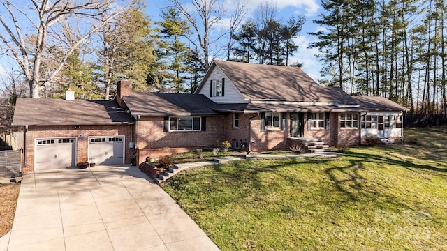 view of front of property with brick siding, an attached garage, a front yard, a chimney, and driveway