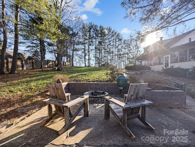 view of patio with a fire pit and fence