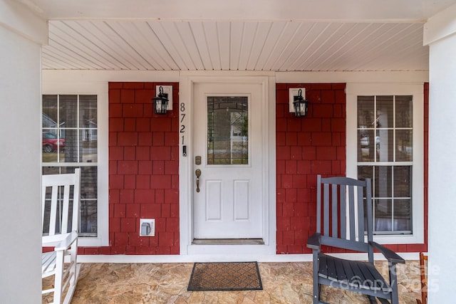 doorway to property featuring covered porch