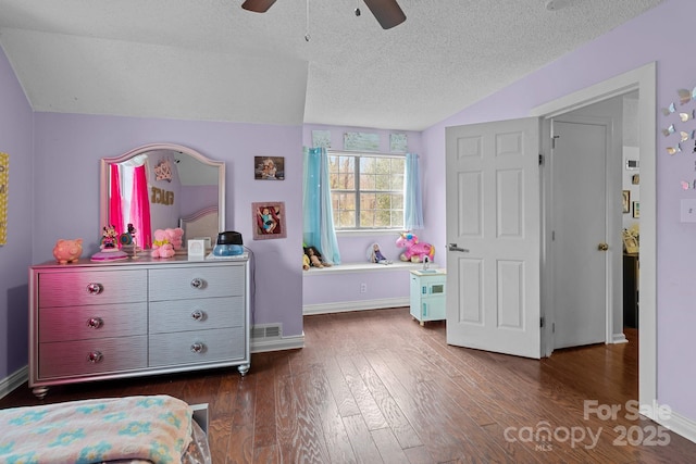 bedroom featuring a textured ceiling, baseboards, vaulted ceiling, and dark wood finished floors