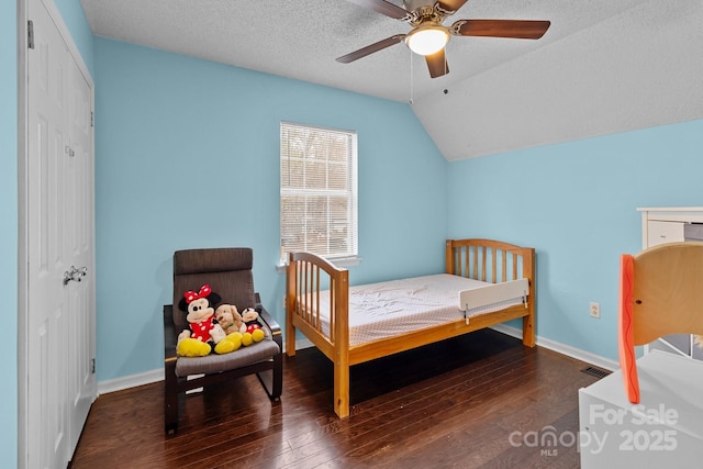 bedroom with lofted ceiling, baseboards, and hardwood / wood-style floors