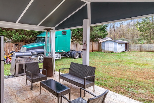 view of patio featuring a shed, an outdoor structure, a fenced backyard, and area for grilling