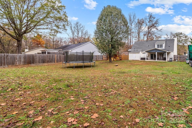 view of yard with a fenced backyard and a trampoline