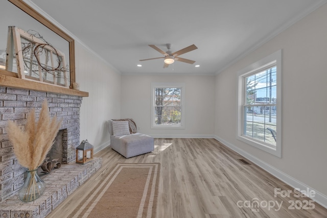 unfurnished room featuring visible vents, ornamental molding, ceiling fan, wood finished floors, and baseboards