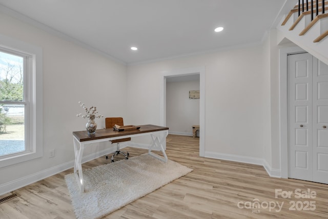 office area with ornamental molding, a healthy amount of sunlight, visible vents, and baseboards