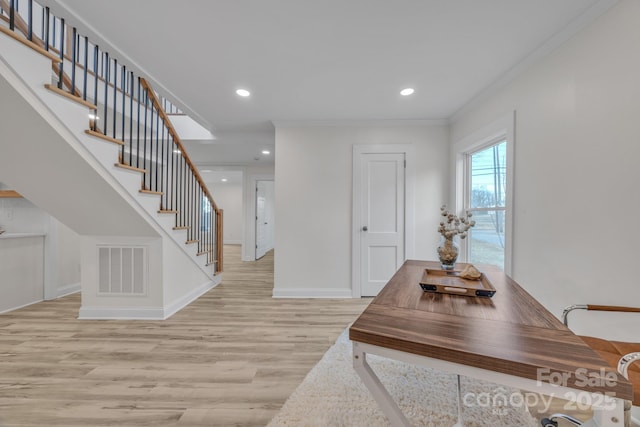 entrance foyer with light wood-style floors, visible vents, crown molding, and recessed lighting