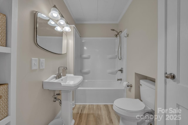 bathroom with toilet, a sink, bathing tub / shower combination, wood finished floors, and ornamental molding