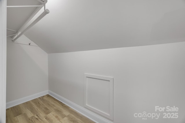 interior space with lofted ceiling and light wood-type flooring