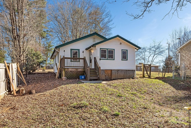 view of front of home featuring fence and a deck