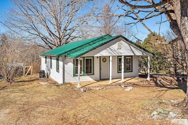 view of front of house featuring metal roof and central air condition unit