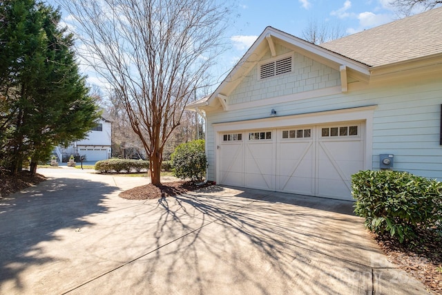 garage featuring concrete driveway