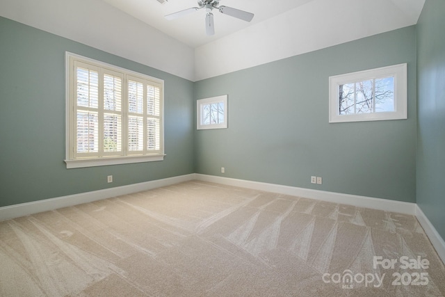 unfurnished room featuring carpet floors, baseboards, and a ceiling fan