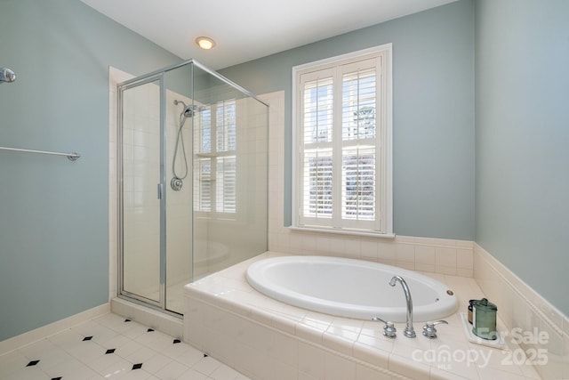 full bathroom with a wealth of natural light, a stall shower, and a garden tub