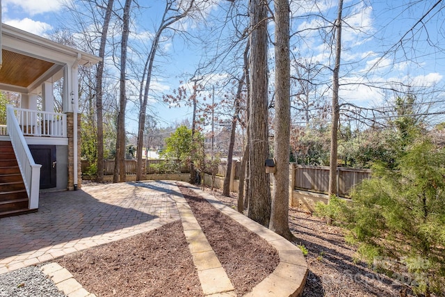 view of yard featuring stairway, a patio area, and a fenced backyard