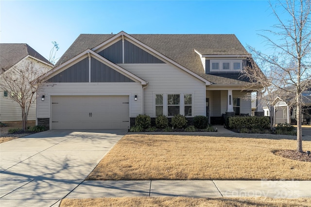 craftsman-style house with driveway, an attached garage, a shingled roof, and a front yard