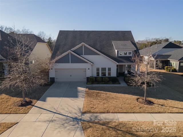 view of front of property featuring driveway, board and batten siding, and an attached garage