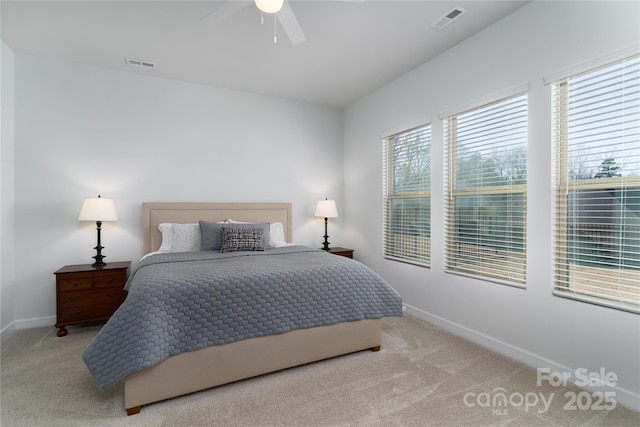 bedroom featuring light carpet, baseboards, and visible vents