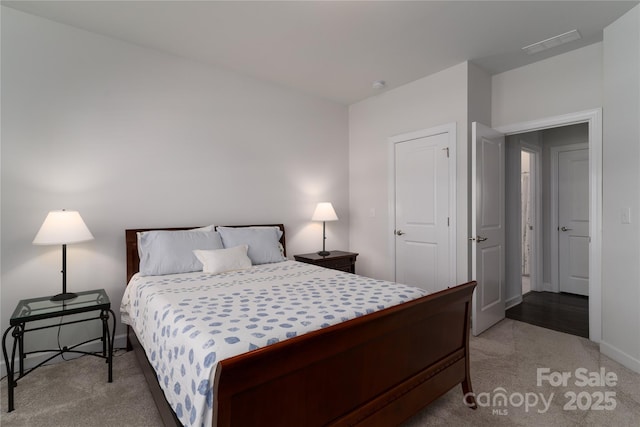 carpeted bedroom with visible vents and baseboards