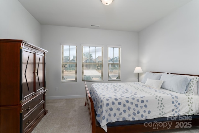 bedroom featuring light carpet, baseboards, and visible vents