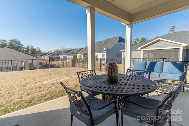 view of patio featuring an outdoor living space, outdoor dining area, a fenced backyard, and a residential view