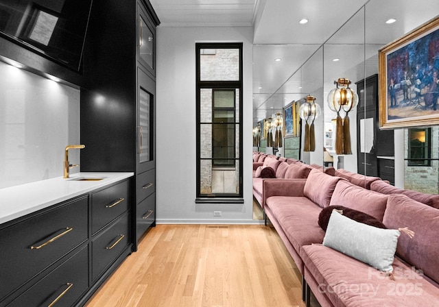 interior space featuring plenty of natural light, recessed lighting, vanity, and wood finished floors