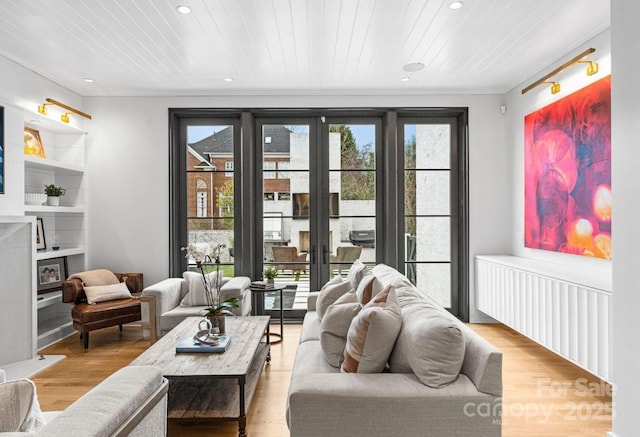 living room featuring wooden ceiling, recessed lighting, light wood-type flooring, and ornamental molding