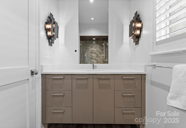 bathroom with vanity, a shower stall, and recessed lighting