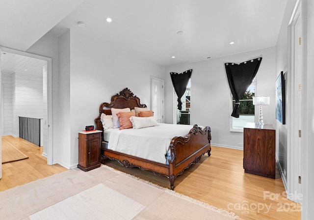 bedroom featuring recessed lighting, light wood-type flooring, and baseboards