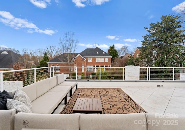 view of patio featuring outdoor lounge area and a balcony